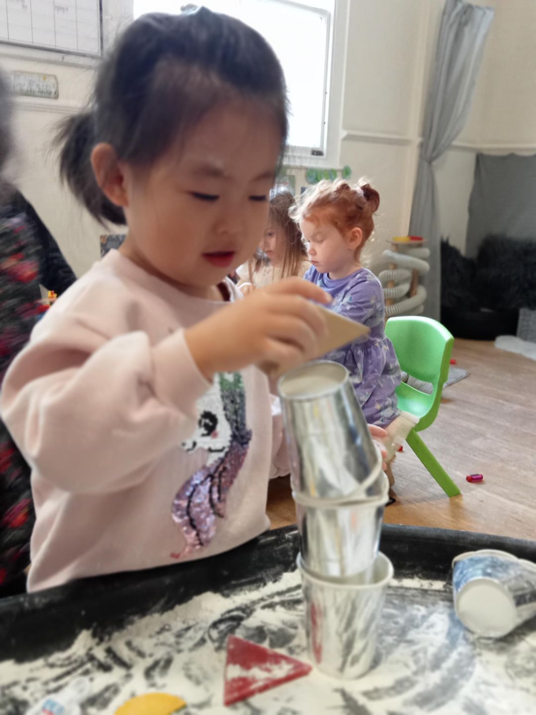 nursery child doing arts and crafts