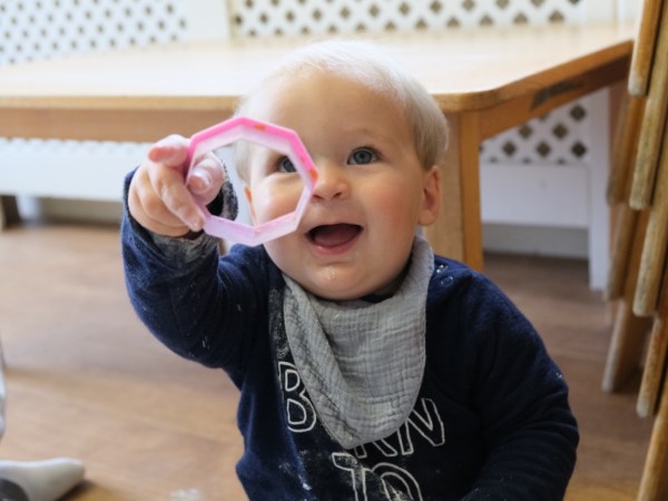 A child at Devon Nurseries engaging in loose parts play