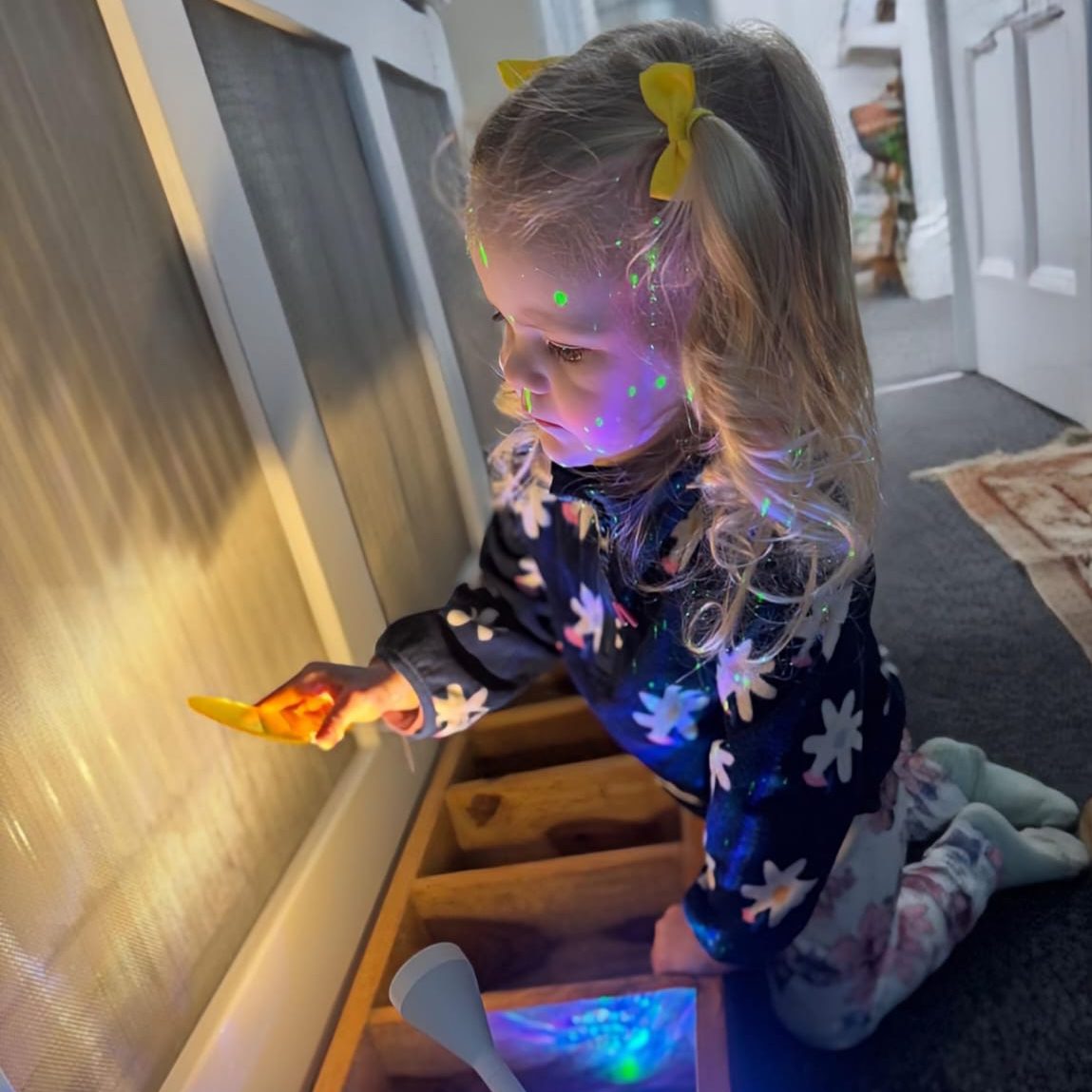 A child exploring lights at Devon Nurseries